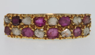 A yellow gold ruby and diamond gem set half eternity ring, size R