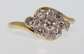 An 18ct yellow gold diamond cluster ring, approx 0.65ct, size M