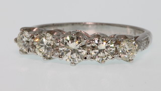 An 18ct white gold 5 stone diamond ring, approx 1.25ct, size N 1/2