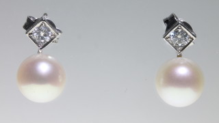 A pair of 18ct white gold brilliant cut diamond and pearl ear studs