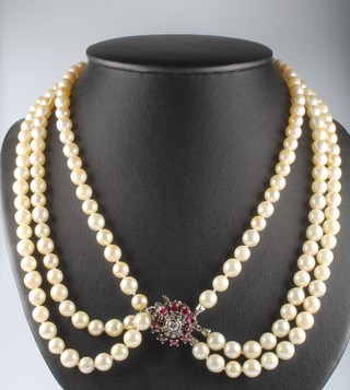 A 3 strand cultured pearl necklace with 14ct white gold clasp set with diamonds and rubies