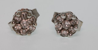 A pair of 14ct white gold gem set ear studs 