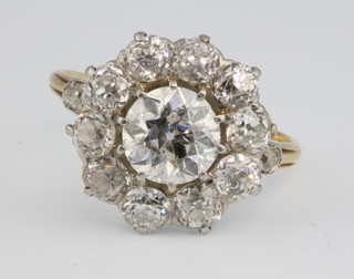 An 18ct yellow gold diamond cluster ring, the centre brilliant approx 1.5ct surrounded by 10 brilliants each 0.20ct with a brilliant to each shoulder, size O