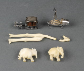 A carved ivory figure of a giraffe, 2 elephants and a  miniature silver taxi and sleigh