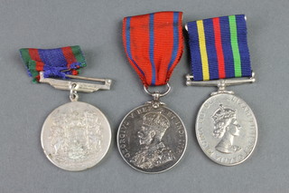 A Coronation Police medal 1911 to P.C. A. Huckle, a Canadian Volunteer Service Medal, a Civil Defence Long Service medal 