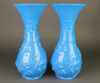 A pair of blue moulded glass baluster vases with flared necks, decorated with scrolling flowers 14" 