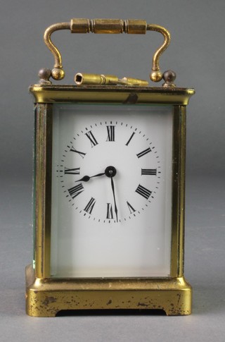 A 19th Century French 8 day carriage timepiece with enamelled dial and Roman numerals contained in a gilt metal case 