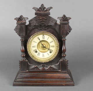 An Ansonia American striking bracket clock with paper dial and Roman numerals contained in a carved oak case  