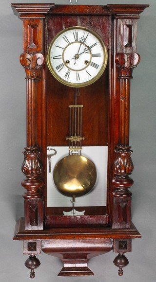 A Vienna style striking regulator with painted dial contained in a mahogany case