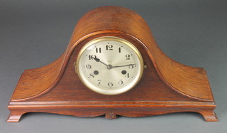A 1930's 8 day chiming mantel clock with silver dial and Arabic numerals, contained in an oak Admirals hat shaped case