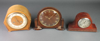 A 1950's Smiths 8 day striking mantel clock with gilt chapter ring, contained in an oak arch shaped case, a 1950's Smiths mantel clock contained in a mahogany arch shaped case and an 8 day timepiece with silvered dial and Arabic numerals contained in a mahogany Admirals hat shaped case 
