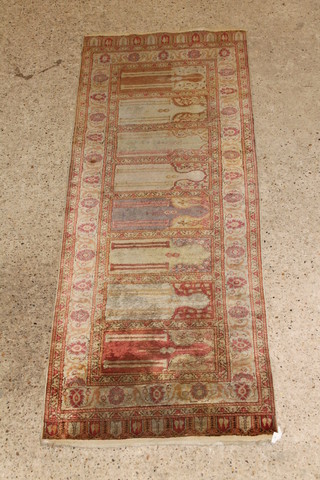An Aubusson Persian style rug with 8 mihrabs to the centre 89" x 34" 