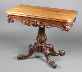A Victorian carved walnut tea table, the apron heavily carved throughout and raised on a bulbous turned tripod base 29"h x 36"w x 17 1/2"d 