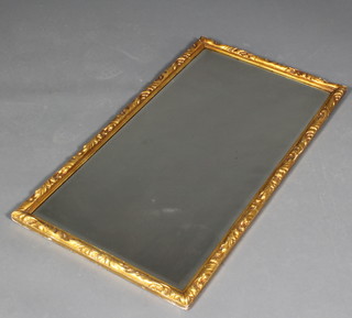 A rectangular bevelled plate wall mirror contained in a decorative gilt frame 41" x 23" 