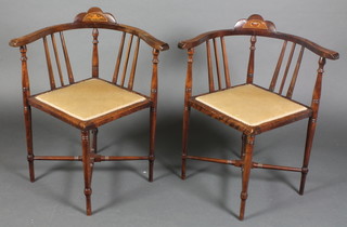 A pair of Edwardian inlaid mahogany corner chairs raised on turned supports with X framed stretcher 