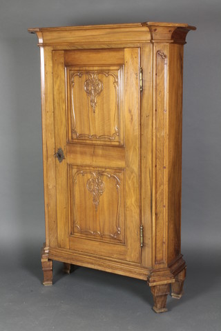 A 19th Century Continental fruitwood cabinet with moulded cornice, the shelved interior enclosed by a panelled door, raised on square tapered supports 64"h x 42"w x 15 1/2"d 