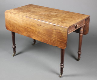 A 19th Century mahogany drop flap table fitted a frieze drawer, raised on turned supports, brass caps and casters 28 1/2"h x 42"w x 21" when closed x 41 1/2" when extended