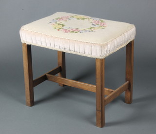 A Georgian style rectangular mahogany stool, the seat upholstered in Berlin woolwork, raised on square tapering supports with H framed stretcher 19"h x 21"w x  15"d 