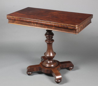 A Victorian mahogany D shaped card table raised on a turned column with circular X frame base 28 1/2"h x 36"w x 18"d 