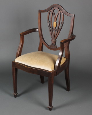 A Hepplewhite style shield back carver chair with pierced back and upholstered seat, raised on square supports 