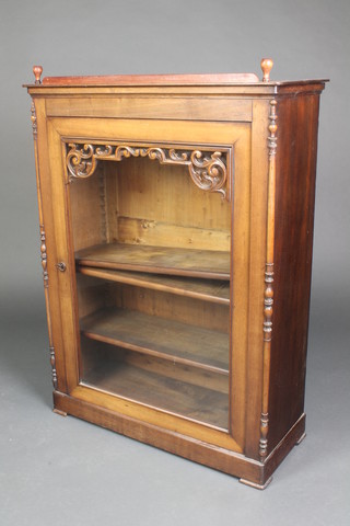 A Victorian walnut Pier cabinet fitted shelves enclosed by a glazed panelled door having turned decoration to the sides 38"h x 29"w x 11 1/2d 