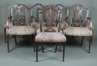 A set of 8 Hepplewhite style mahogany shield back dining chairs (2 carvers and 6 standard) with upholstered seats, raised on square tapering supports, spade feet 