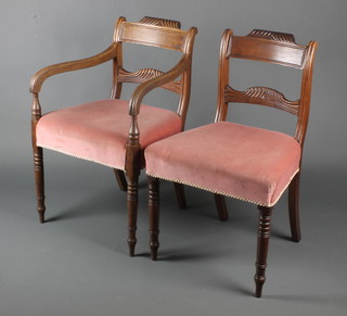 A set of 6 Regency mahogany bar back dining chairs with carved mid rails and over stuffed seats, raised on turned supports, 1 with arms 