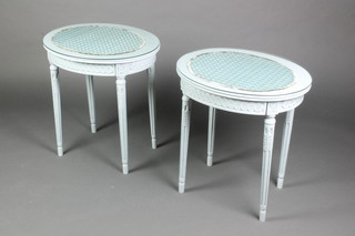 A pair of turquoise painted oval Empire style lamp tables fitted drawers, raised on turned and reeded supports 22"h x 20 1/2"w x 17"d 