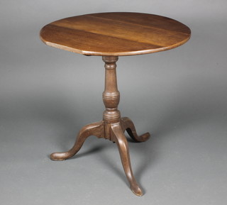A 19th Century Country oak circular snap top tea table raised on a turned column and tripod base 25"h x 28" diam. 