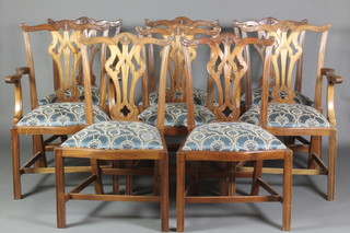 A set of 8 Chippendale style dining chairs of serpentine outline with upholstered drop in seats, raised on square tapering supports united by an H framed stretcher, 2 carvers, 6 standard 