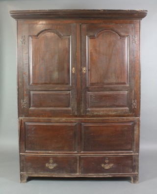 An 18th Century oak press cabinet with moulded cornice enclosed by arch panelled doors, the base fitted 3 long drawers 77"h x 59"w x 20"d 