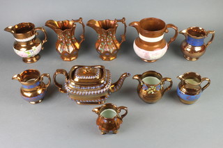 A collection of Victorian lustre teapots and jugs 