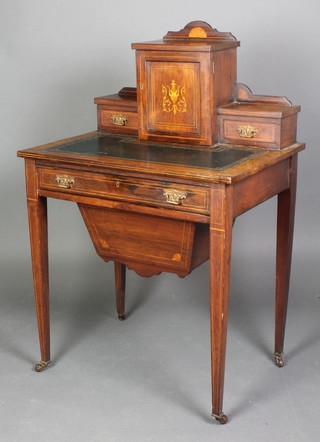 A Victorian inlaid rosewood writing/work table, the raised superstructure to the back fitted a cupboard flanked by a pair of drawers with inset green writing surface above 1 long drawer, having a deep basket and raised on square tapered supports 42"h x 27 1/2"w x 19 1/2"d