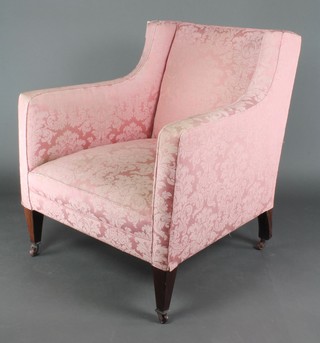 An Edwardian armchair upholstered in pink sculpted material on square supports 