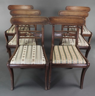 A set of 6 Georgian mahogany bar back dining chairs with shaped mid rails and upholstered drop in seats, raised on front and rear sabre supports