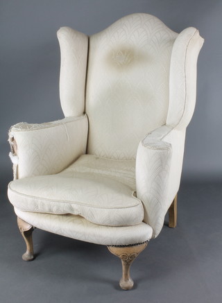 A Queen Anne style armchair upholstered in white material raised on cabriole supports