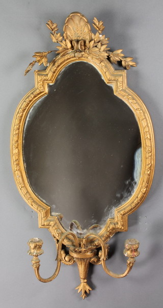 A 19th Century shaped plate mirror contained in a decorative gilt frame with 2 candle sconces to the base 36"h x 13"w 