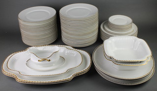 A mid 20th Century German gilt decorated dinner service comprising 7 small plates, 3 side plates, 40 dinner plates, 8 soup bowls and 3 quatrefoil meat plates, a sauce boat, 2 square bowls and 3 circular serving dishes 