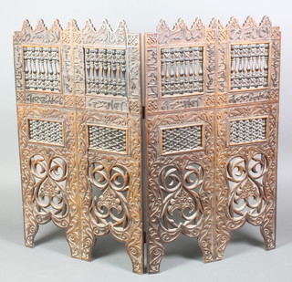 A Moorish style carved and pierced hardwood screen 35"h x 20 1/2" when closed  x 41 1/2" when open 