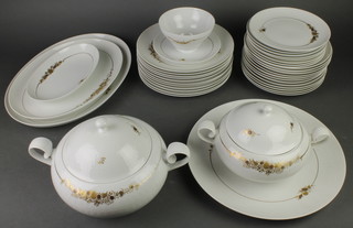 A Rosenthal gilt decorated floral dinner service comprising 2 tureens and covers, a bowl, 9 side plates, 12 shallow bowls, 11 dinner plates, 5 serving dishes