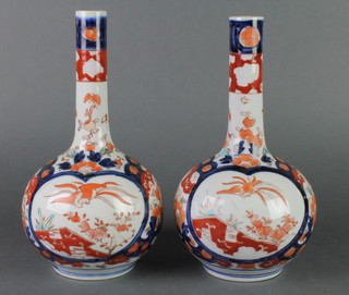 A pair of 19th Century Imari bottle vases decorated with birds and flowers 10" 