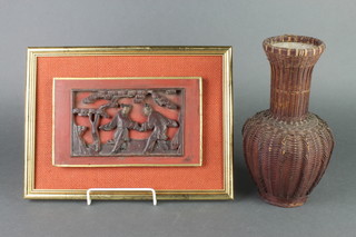 A Japanese carved wooden panel framed and a wicker covered vase