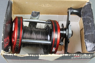An Abu 6000 fishing reel, boxed and with spinner 