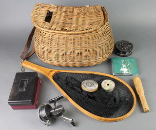 A pot bellied fishing creel containing a collection of various fly reels, including Daiwa, Mitchell spinning reel, Hardy fly box etc 