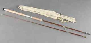 A Milbor 8' spinning rod with original cloth sleeve and label 