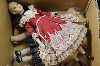 A porcelain headed doll, various doll parts etc 