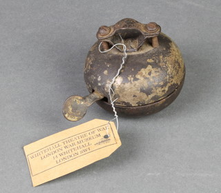 A circular metal bicycle bell decorated a Swastika and with label marked Whitehall Theatre of War, London War Museum, 14 Whitehall, London