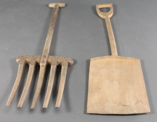 A wooden malt shovel and fork 