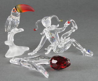 A Swarovski figure of a Pierrot, a ditto of a seated Toucan and a tulip 