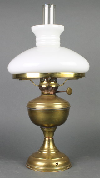 A 19th Century brass oil lamp with opaque shade and clear glass chimney 